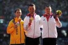 A picture of men on a podium with medals around their neck