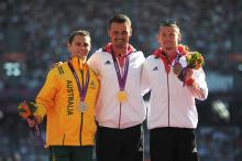 A picture of men on a podium with medals around their neck