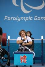 A picture of a powerlifter on a bench celebrating 