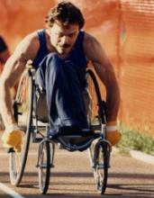 A picture of a man in wheelchair during a wheelchair athletics race.