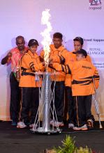 Athletes from host country Malaysia light the cauldron  up the Games cauldron during opening of the Games