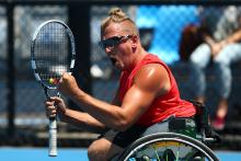 Dylan Alcott celebrates winning his quad wheelchair tennis singles match against Great Britain's Andy Lapthorne at the 2014 Australian Open. 