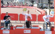 Switzerland's Marcel Hug on top of the 2014 London Marathon podium from David Weir and Ernst Van Dyk