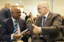 Sam Ramsamy and Sir Philip Craven talking and smiling 