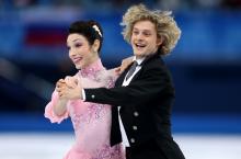 Man and Woman in a dancing position on the ice, smiling