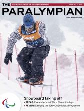 Cover photo of the magazine Paralympian showing snow-boarder on the slope.