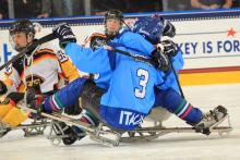 Andrea Macri receives hugs from his Italian teammates after scoring in a preliminary round game.