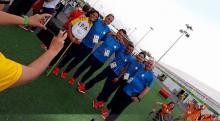 A group of people pose at the Rio 2016 Athlete Village