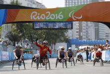 Lihong Zou of China celebrates as she win Gold Medal ahead of Tatyana McFadden USA in Silver Medal position in the Women's T54 Marathon at the Rio 2016 Paralympic Games.