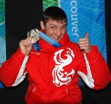 A picture of a man in equilibrium on his wheelchair during a medal ceremony