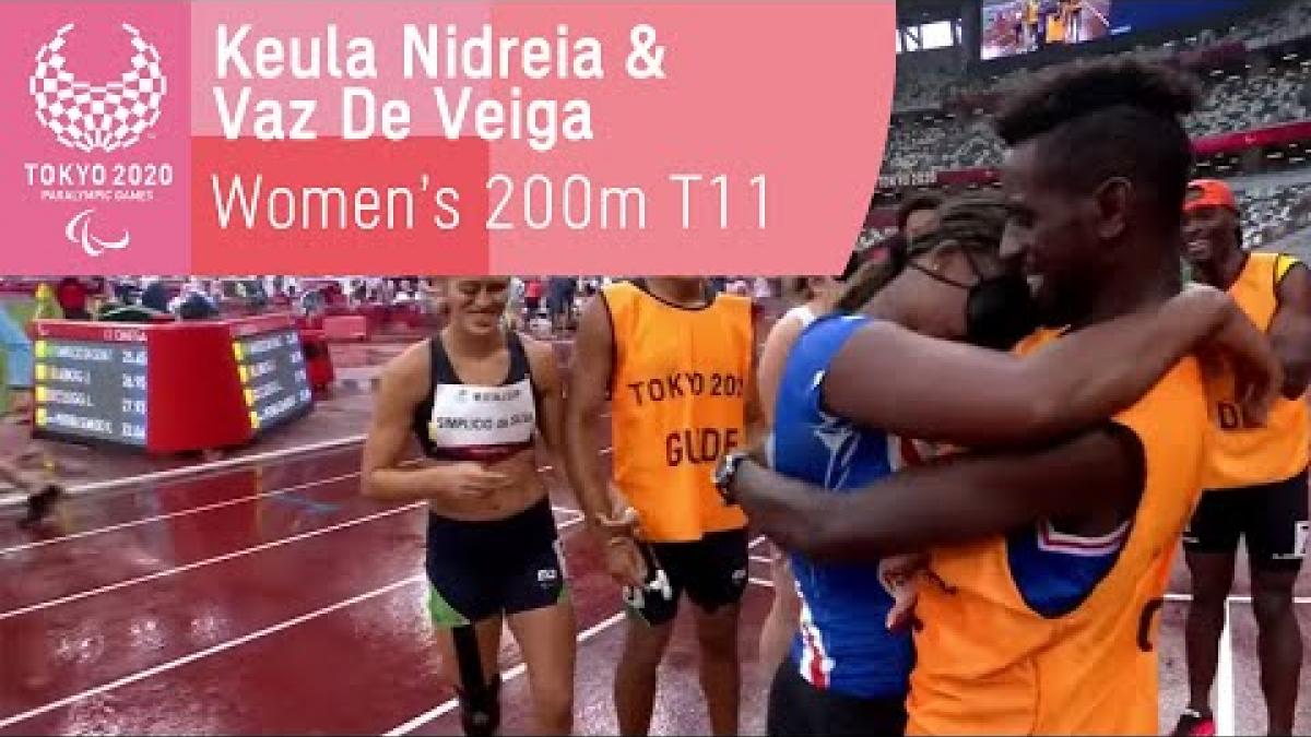 Guide Manuel Antonio Vaz da Veiga proposes to sprinter Keula Semedo on the track after they race in the women's 200m T11 heat at Tokyo 2020.