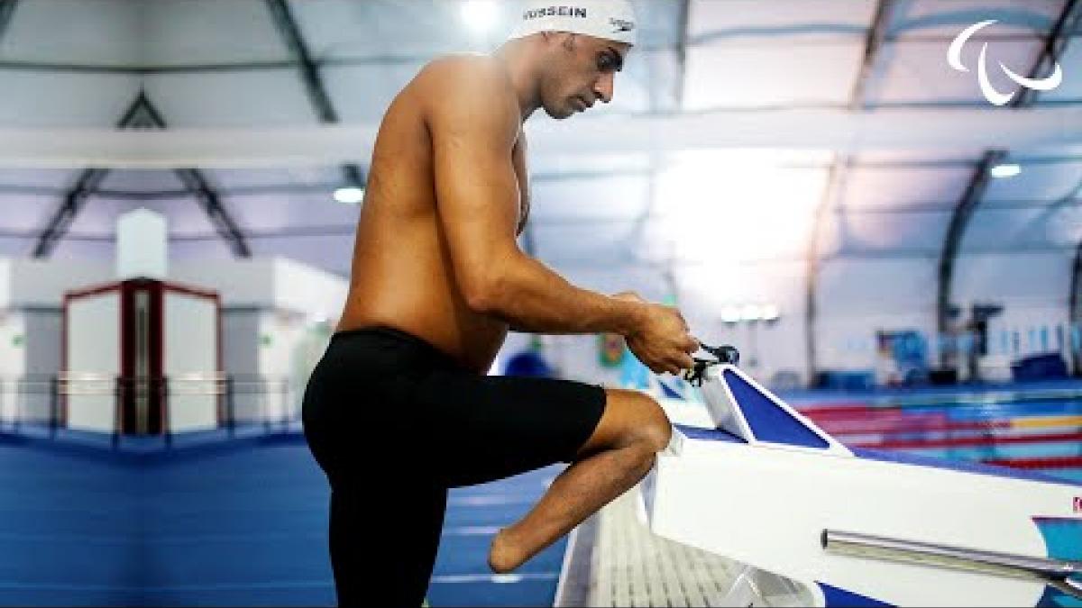 Video Thumbnail of a male Para swimmer getting ready on the starting block. 